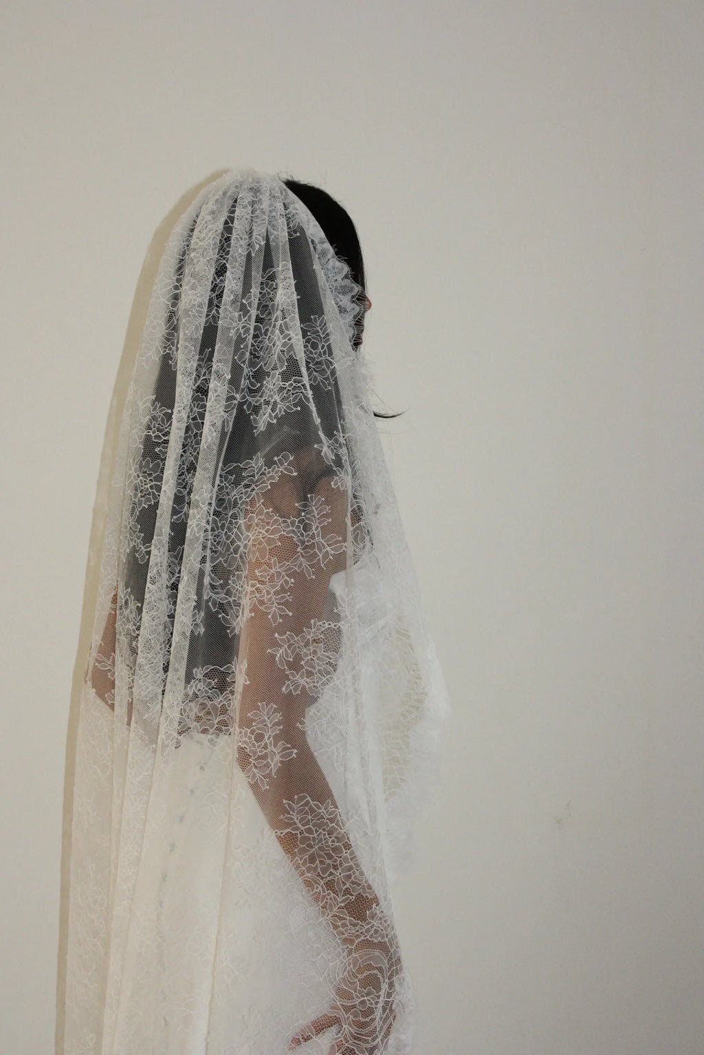 Cathedral-length bridal veil made from soft off-white tulle with full Chantilly lace all over. Lightweight, romantic, and beautifully detailed for a timeless bridal look.