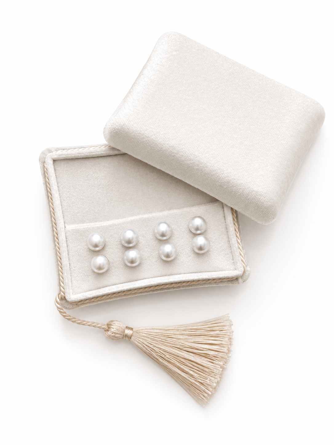 Set of pearls on a jewelry box with a tassel on a white background
