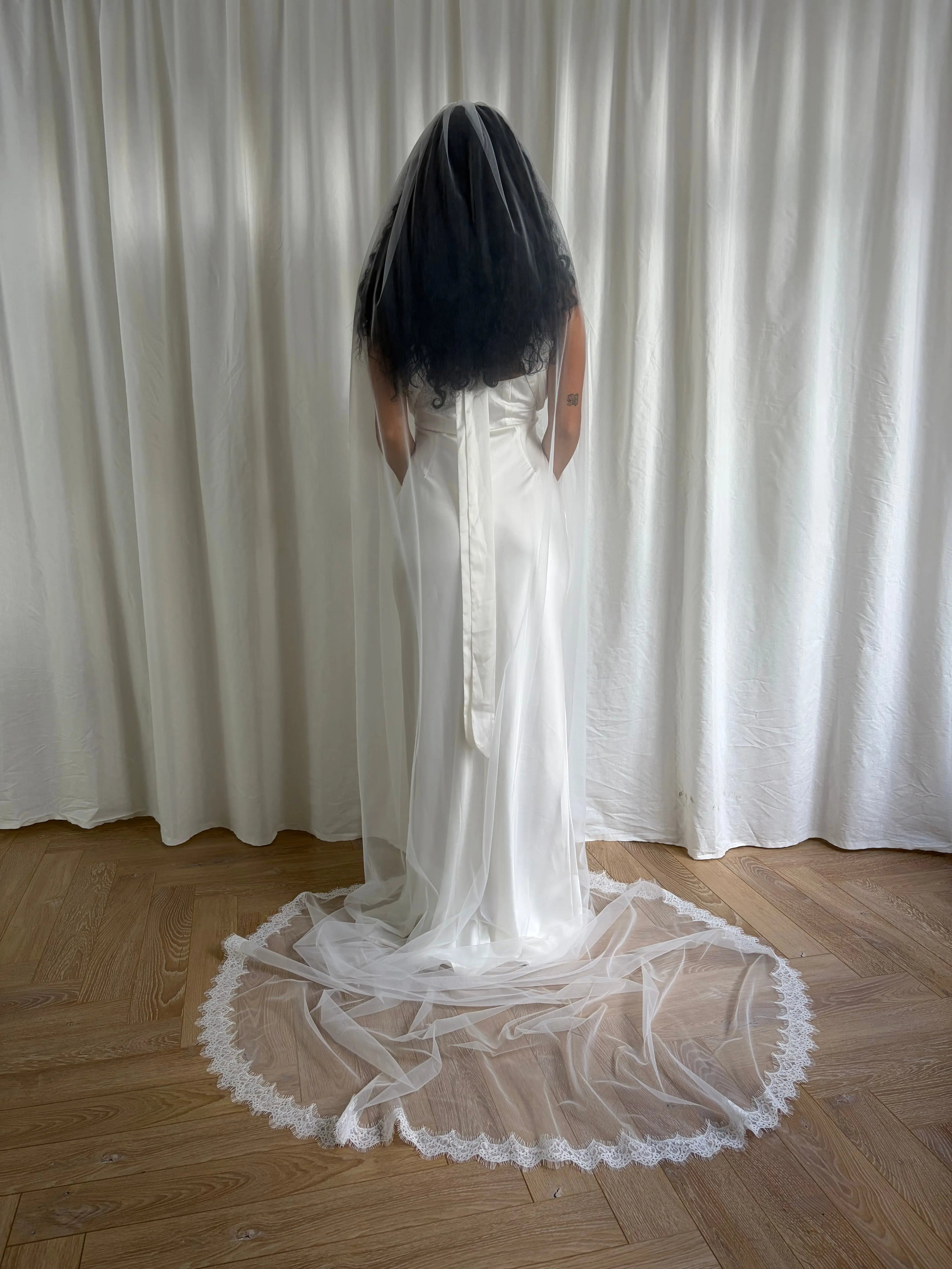 Single-tier vintage lace trim cathedral veil with a soft, cloak-like fall in lightweight tulle — romantic and ethereal bridal design.