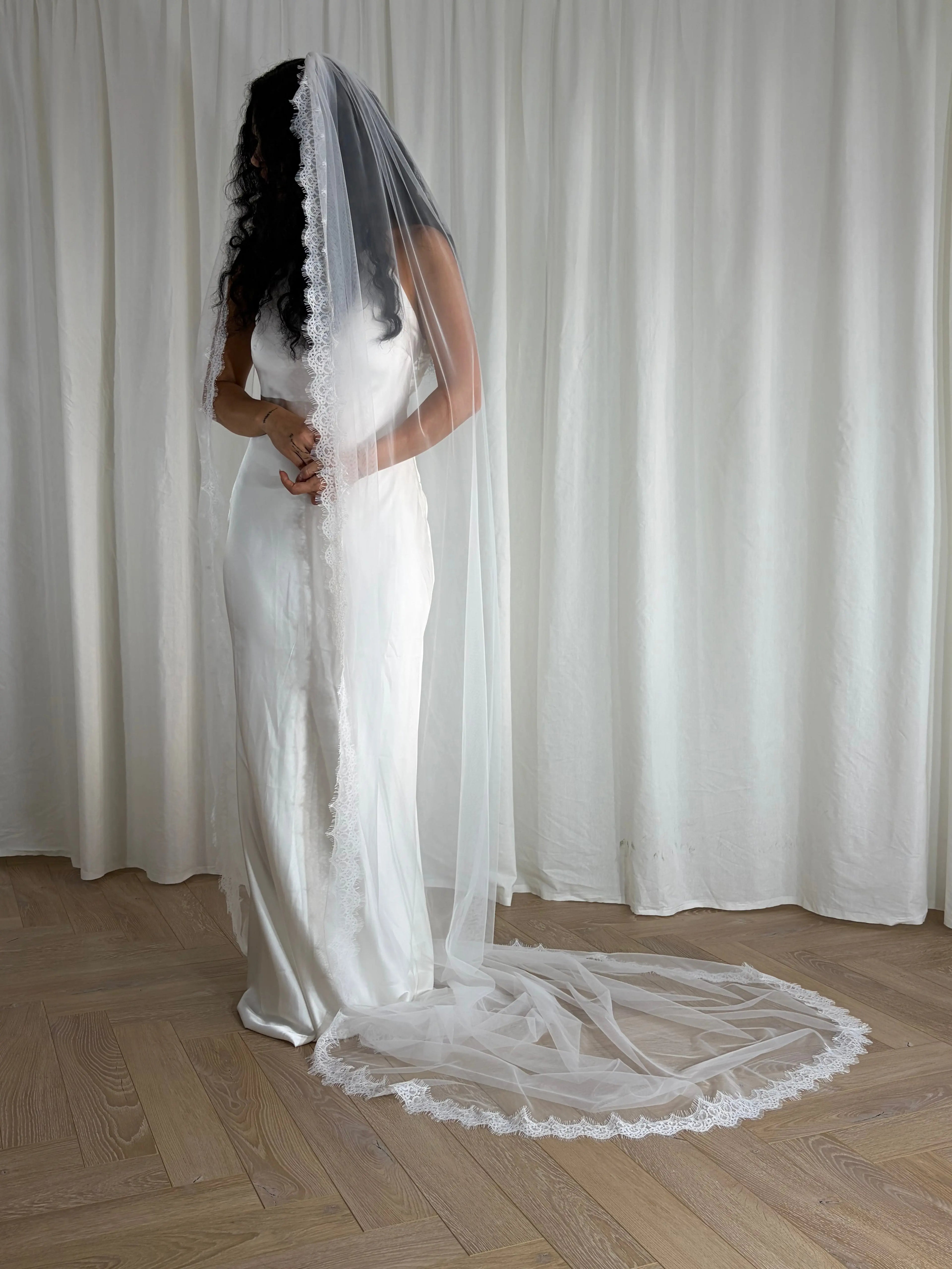 Single-tier vintage lace trim cathedral veil with a soft, cloak-like fall in lightweight tulle — romantic and ethereal bridal design.